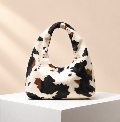 Calyra Animal-Print Hobo Bag — warm beige studio background