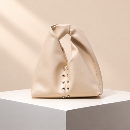 Avelune Knotted Handle Bag — warm beige studio background