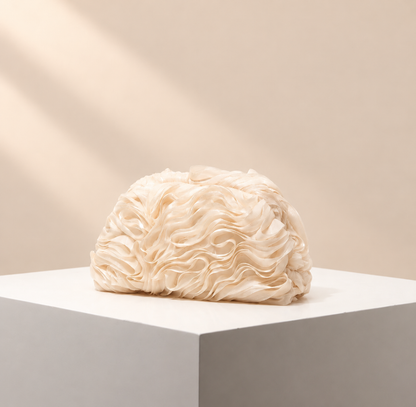 Celestine Textured Occasion Clutch — warm beige studio background