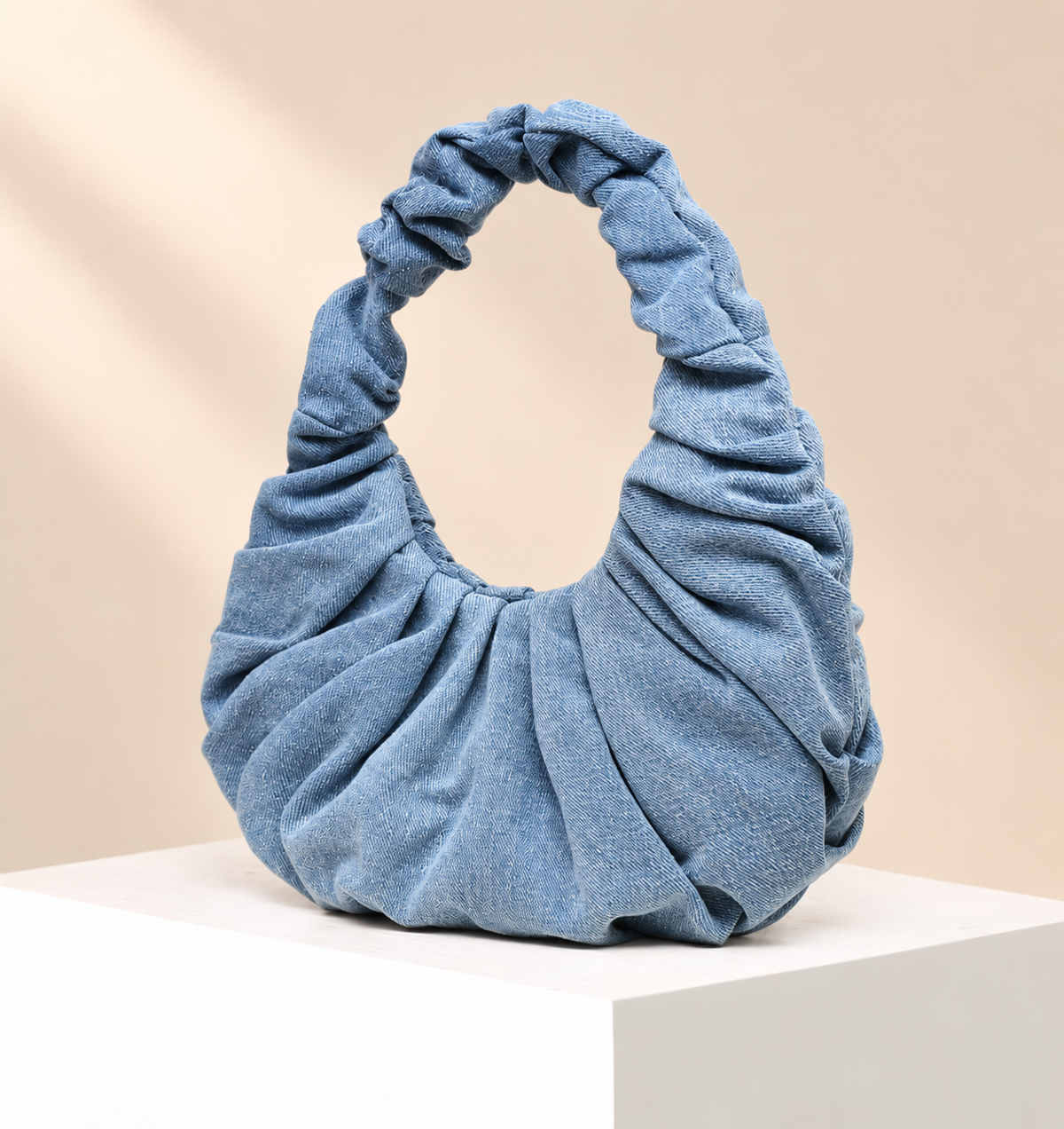 Denimelle Ruched Shoulder Bag — warm beige studio background