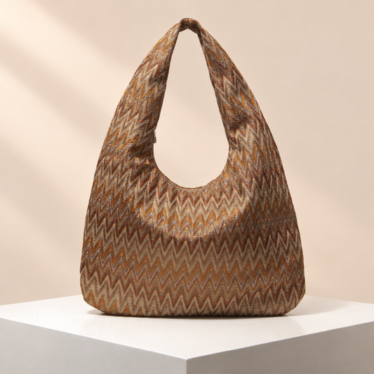 Vachette Patterned Hobo Bag — warm beige studio background