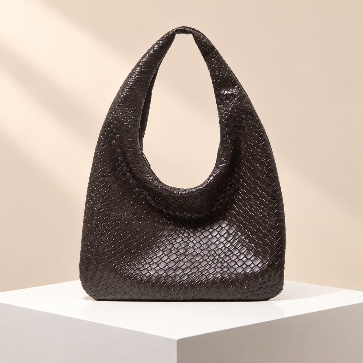 Veloura Textured Hobo Bag — warm beige studio background