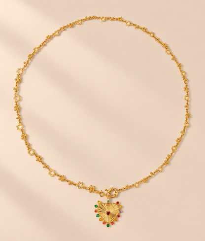 Coeurielle Hollow Heart Pendant Necklace — warm beige studio background