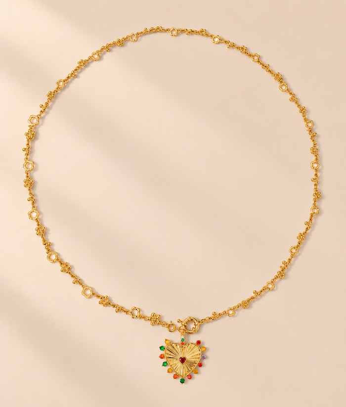 Coeurielle Hollow Heart Pendant Necklace — warm beige studio background