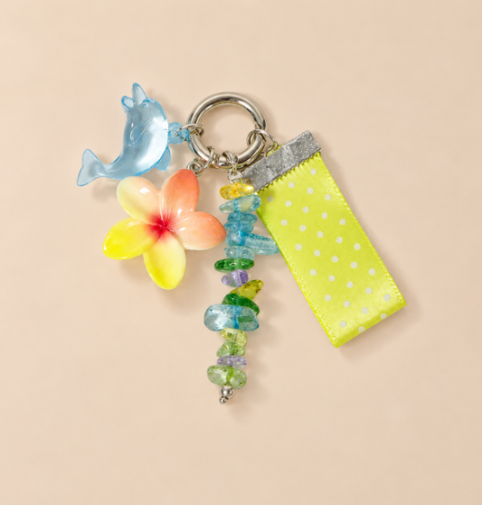 Solmara Tropical Dolphin Bag Charm — warm beige studio background
