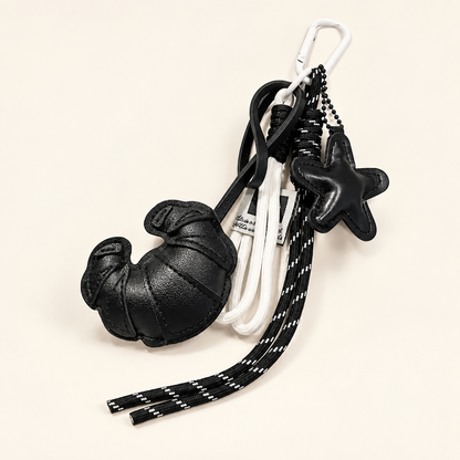 CocoaStar Croissant Leather Bag Charm — Black — ivory studio photograph