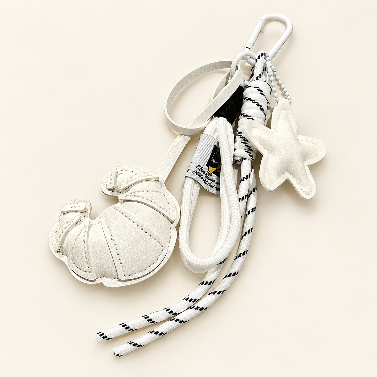 CocoaStar Croissant Leather Bag Charm — White — ivory studio photograph