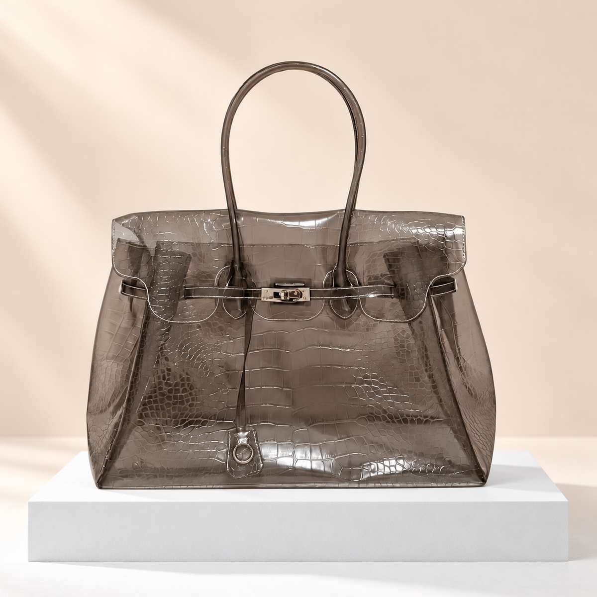 Crocelle Crocodile-Effect Jelly Tote Bag — white plinth, warm beige background