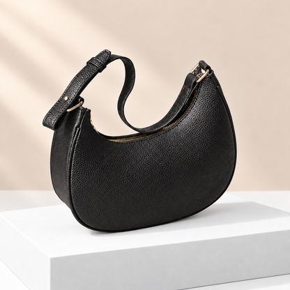 Mirevane Crescent Shoulder Bag — white plinth, warm beige background
