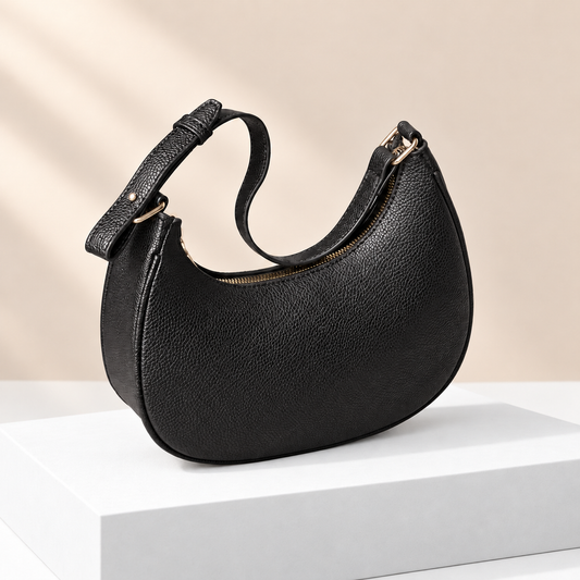 Mirevane Crescent Shoulder Bag — white plinth, warm beige background
