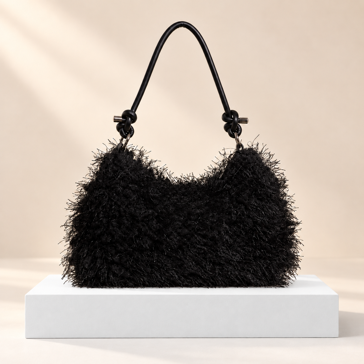 Noirelle Fluffy Shoulder Bag — white plinth, warm beige background