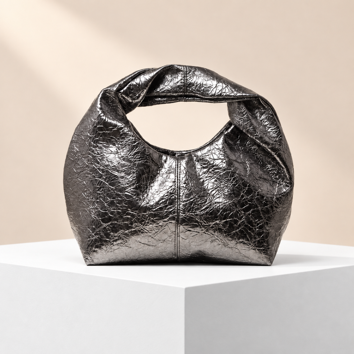 Noirenne Ruched Top Handle Bag — white plinth, warm beige background