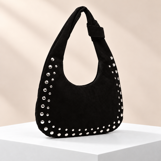 Rivelle Studded Hobo Bag — white plinth, warm beige background