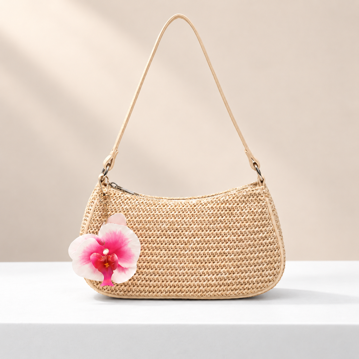Maripelle Orchid Shoulder Bag — white plinth, warm beige background
