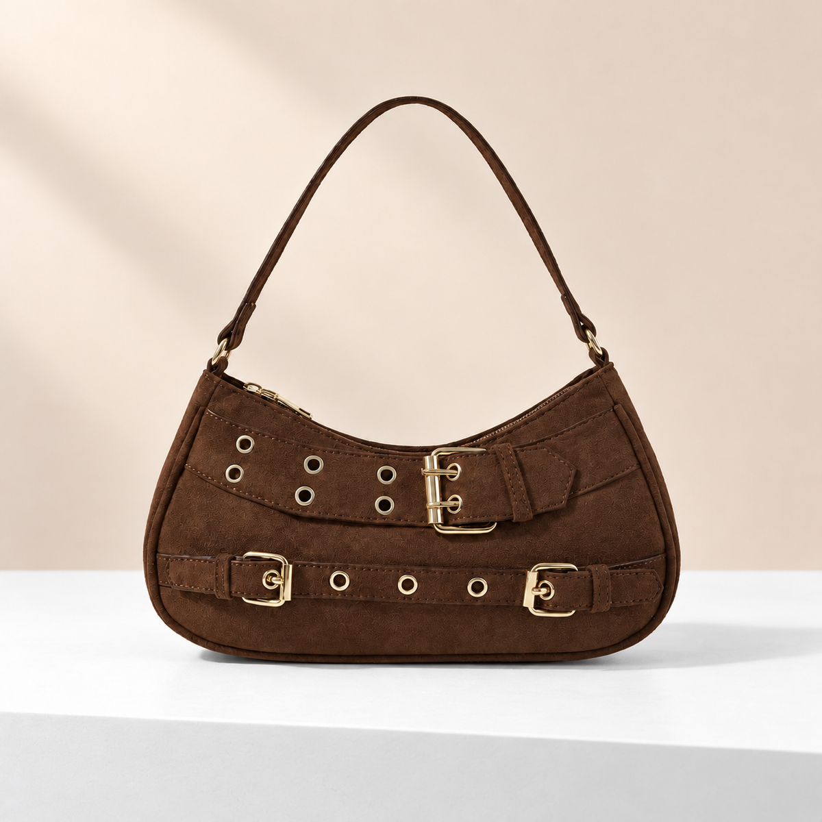 Montaire Buckle Shoulder Bag — white plinth, warm beige background