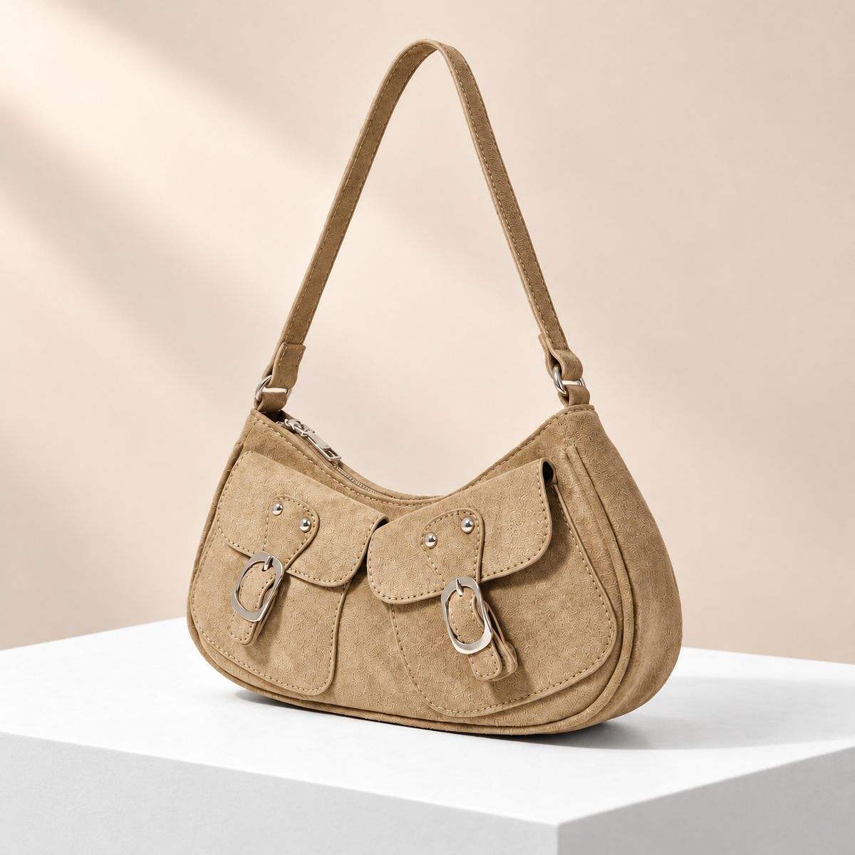 Velmora Pocket Shoulder Bag — white plinth, warm beige background