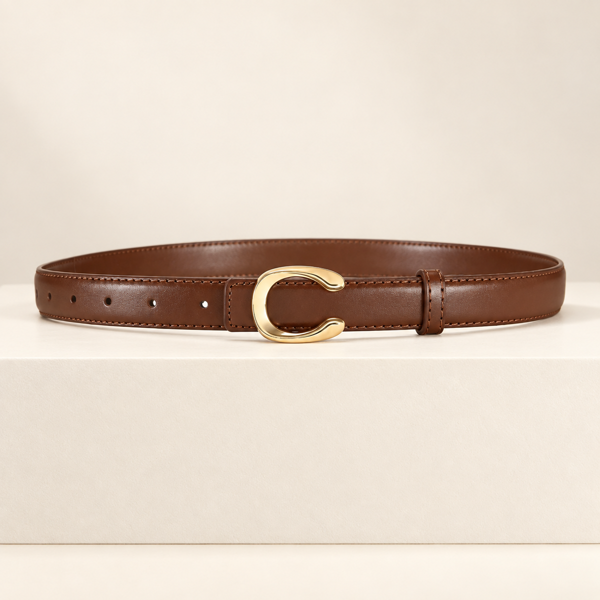 Céliane Letter Buckle Belt — ivory studio gallery photograph