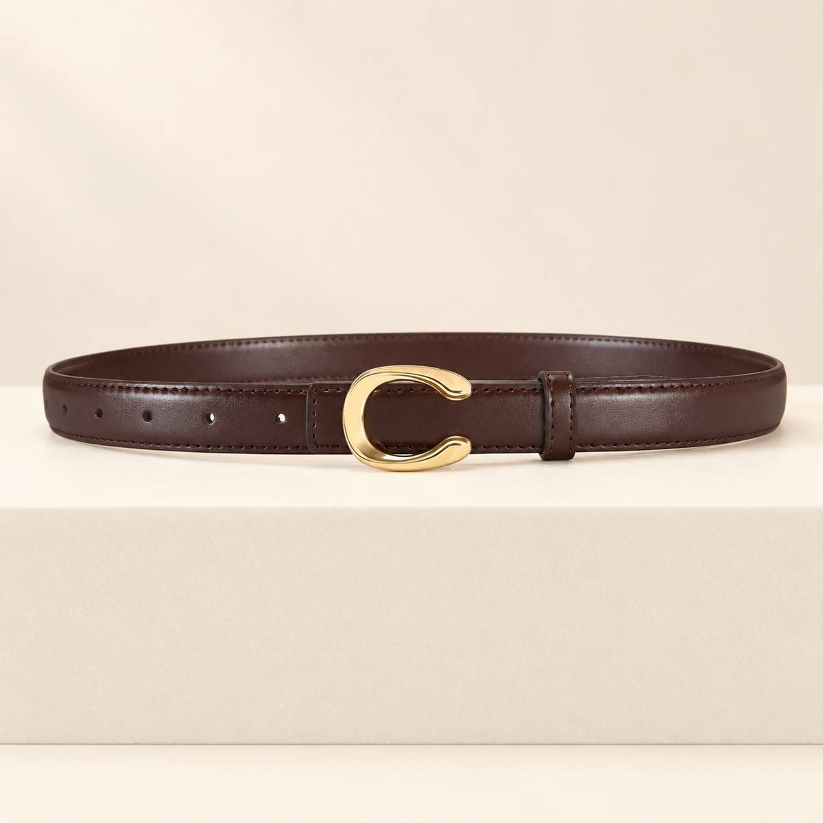 Céliane Letter Buckle Belt — ivory studio gallery photograph