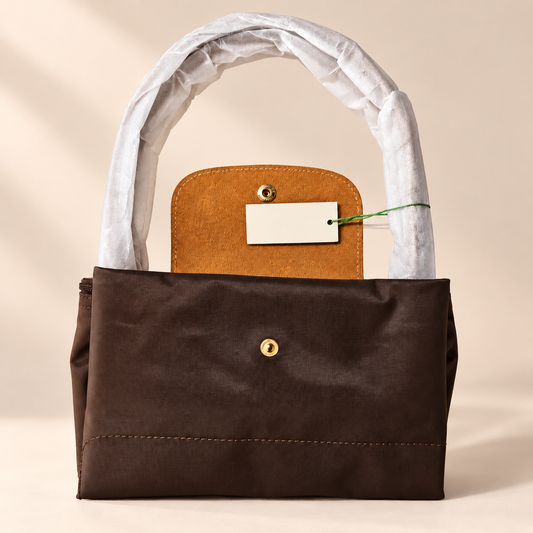 Amelisse Foldable Nylon Tote Bag — warm beige studio background