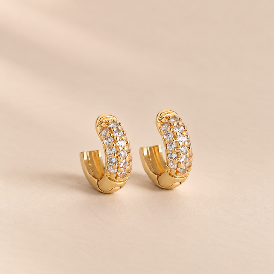 ElaraHug CZ Huggie Hoop Earrings — warm beige studio background