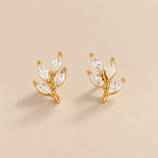 Crystal Leaf Stud Earrings — warm beige studio background