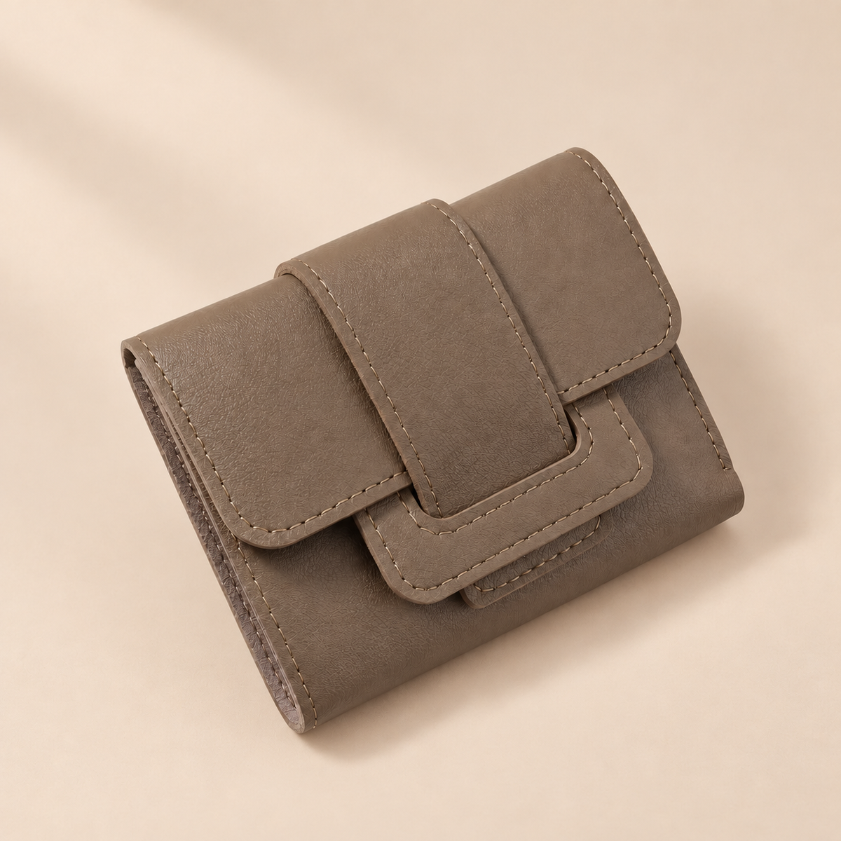 Camille Coffee Brown Trifold Wallet — warm beige studio background
