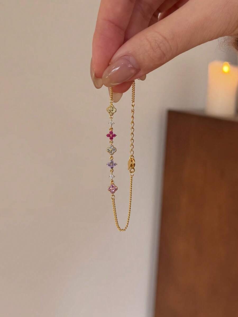 Fleurine 18K Gold-Plated Clover Bracelet – Multicolour Rhinestones — Bracelet held vertically
