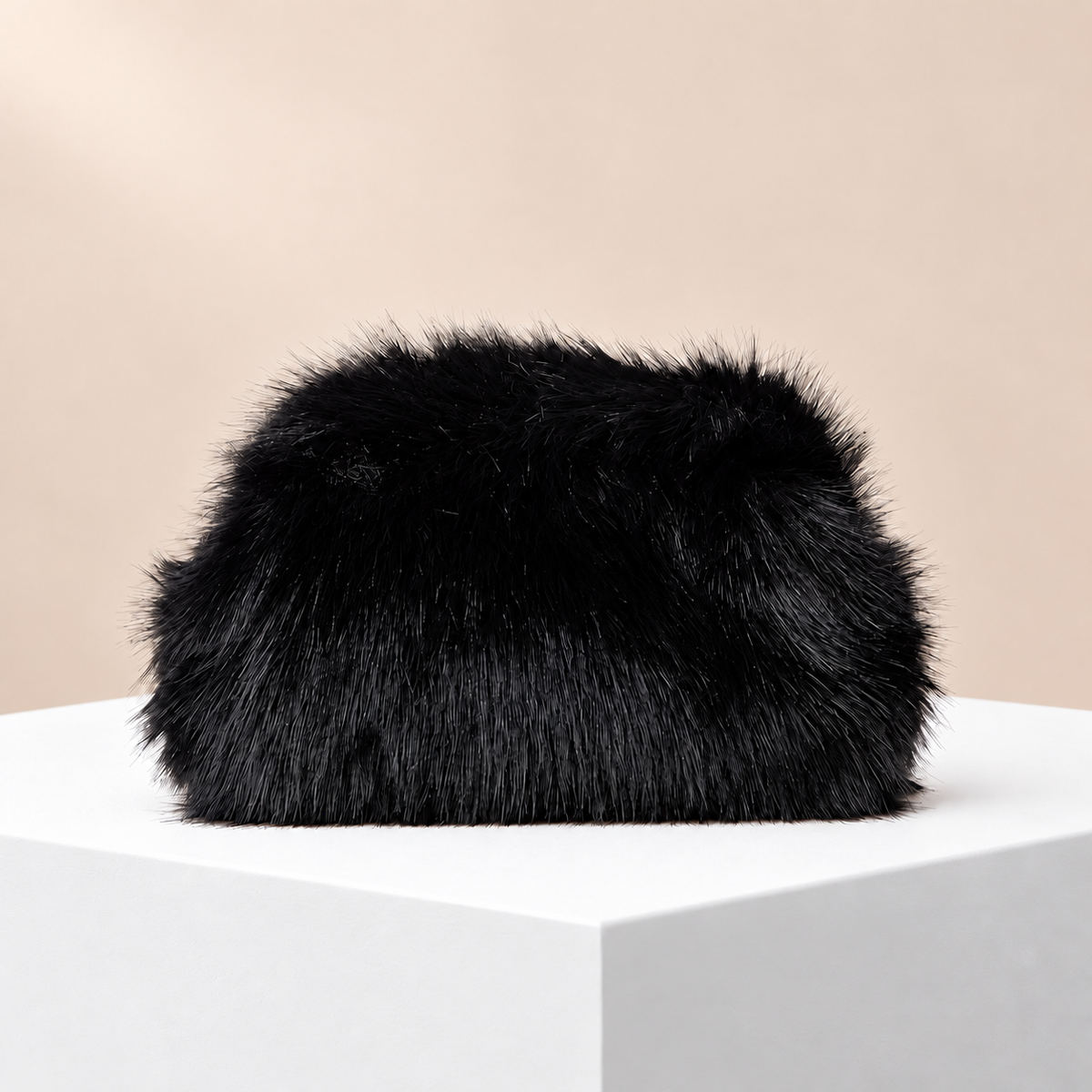 Noélie Black Faux Fur Clutch — white plinth, warm beige background