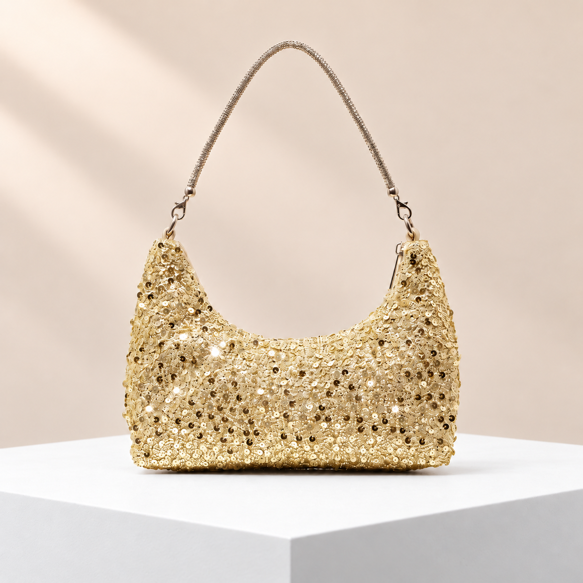 Seraphine Gold Sequin Shoulder Bag — white plinth, warm beige background